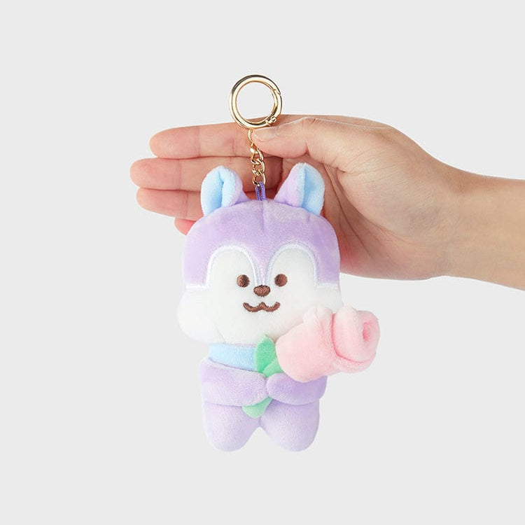 Purple and white plush keychain with a pink rose held in its arms.