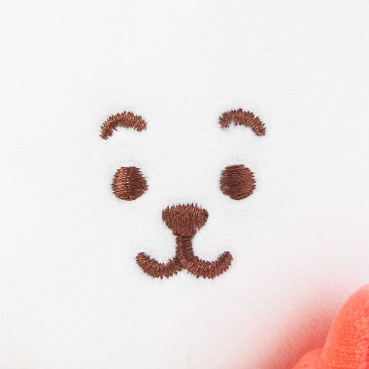 Close-up of white plush face with brown embroidered details.