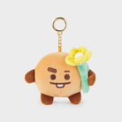Plush brown cartoon character with yellow flower keychain.