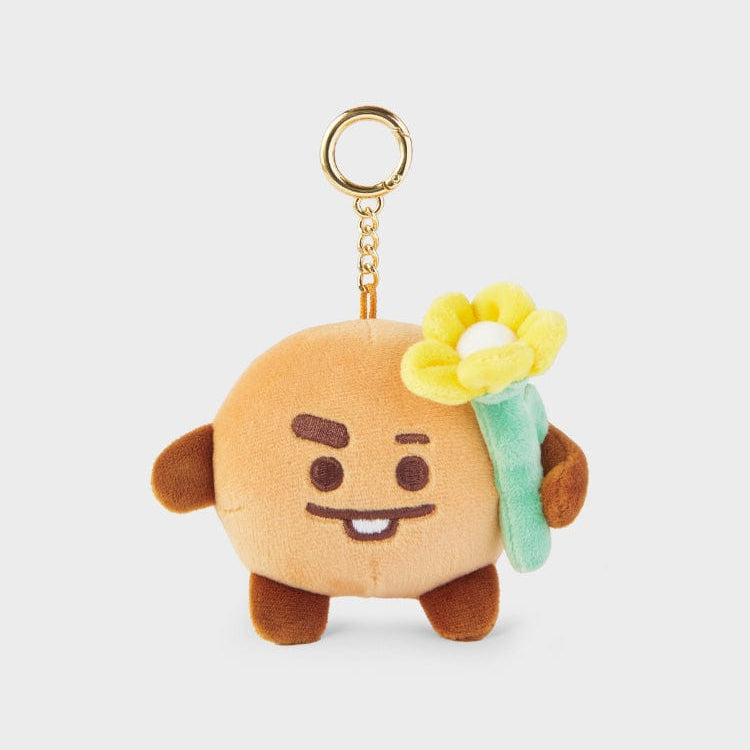 Plush brown cartoon character with yellow flower keychain.
