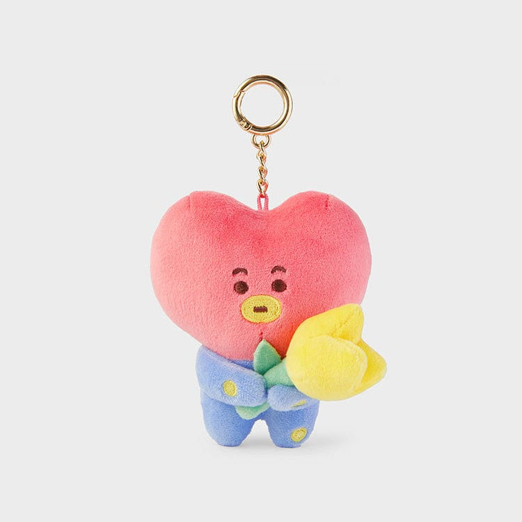 BT21 TATA plush keychain holding a yellow flower.