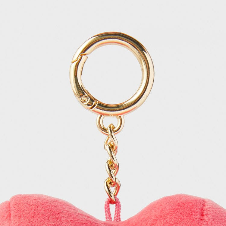 Gold keychain with pink plush toy.