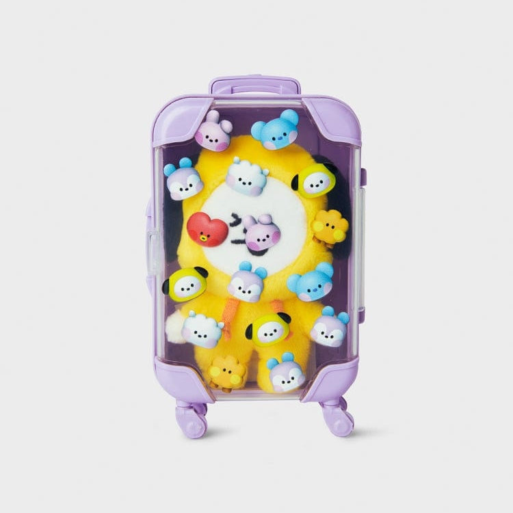 Yellow Chimmy plush inside purple, clear suitcase.