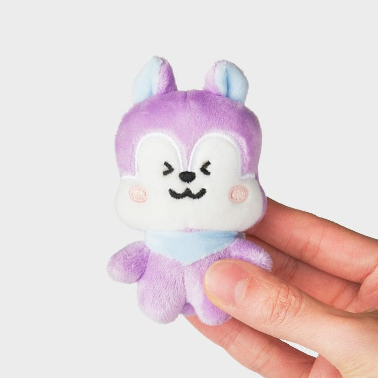 Purple and blue stuffed animal with blush, held in a hand.