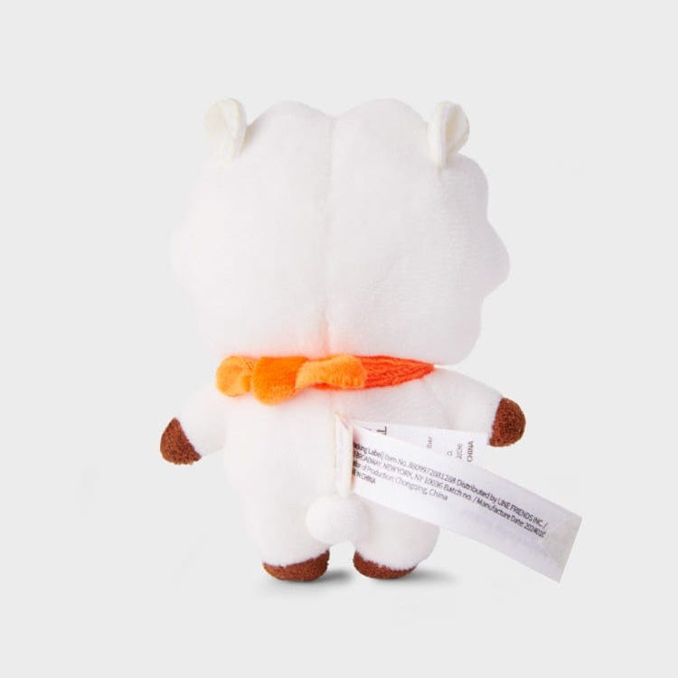 Back view of a white plush toy with a bright orange scarf.