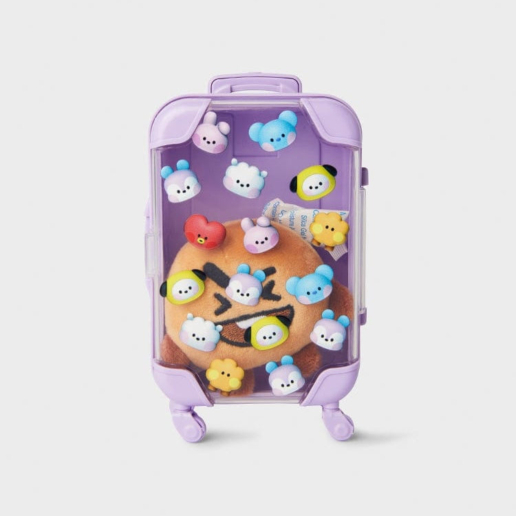 Clear purple suitcase with plush toy and tiny character faces.