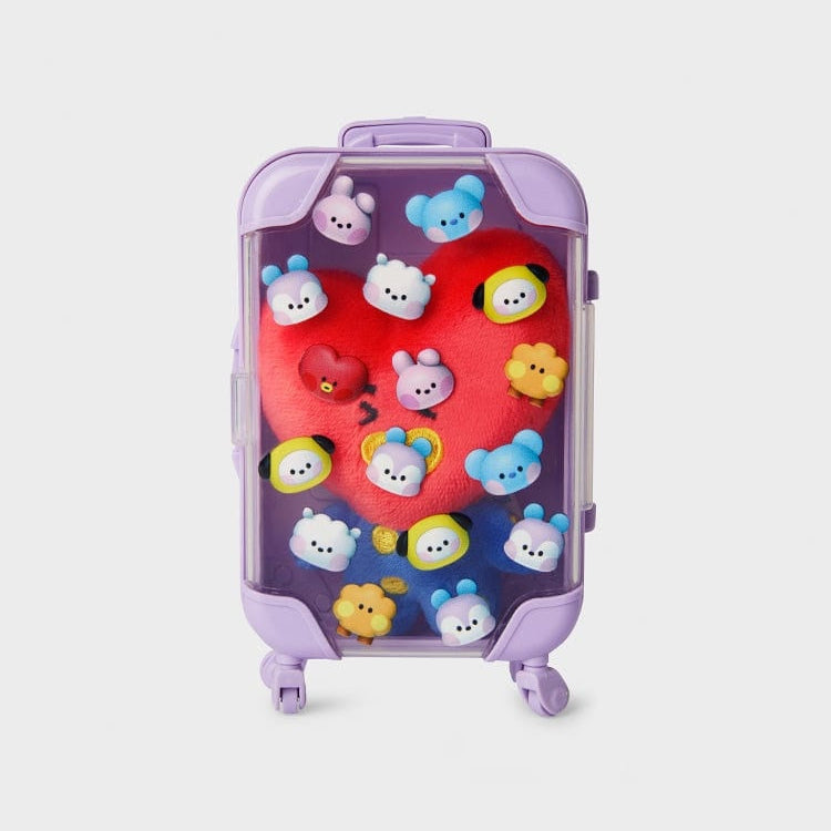 Purple suitcase with colorful plush charms.