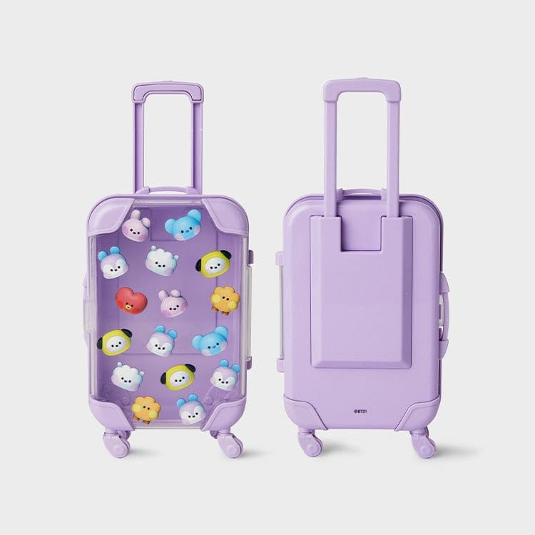 Two purple suitcases, one transparent with cartoon character pins.