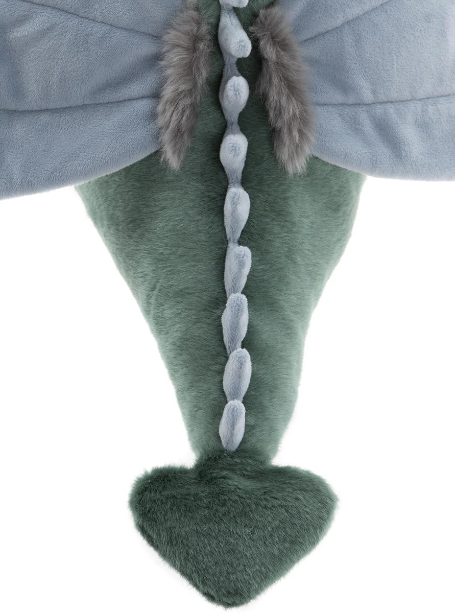 Close-up of a green dinosaur toy with a gray cape and fur details on a white background