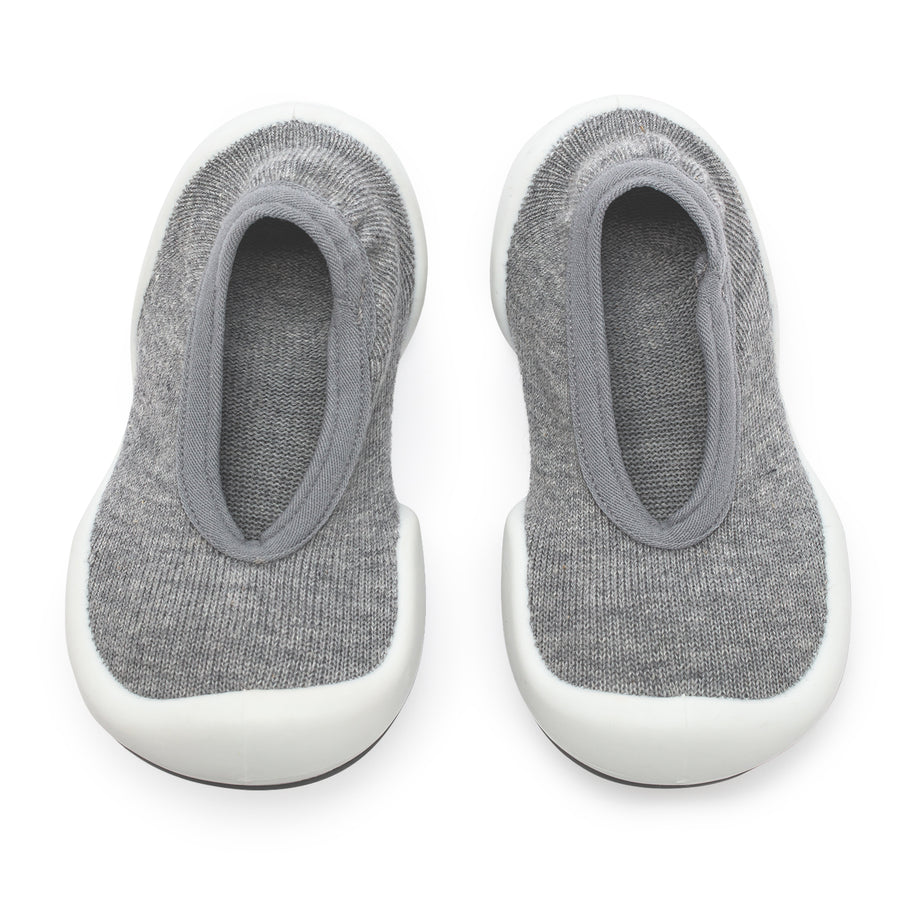 Two gray sock shoes with white soles.