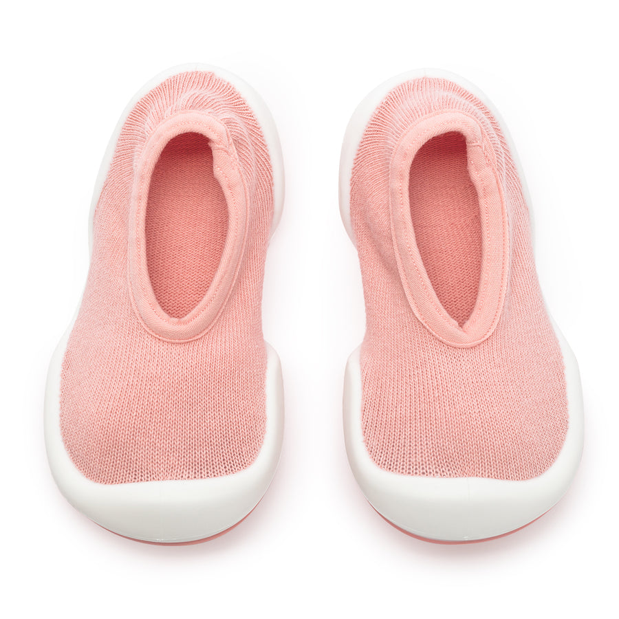 Pair of pink and white baby shoes.