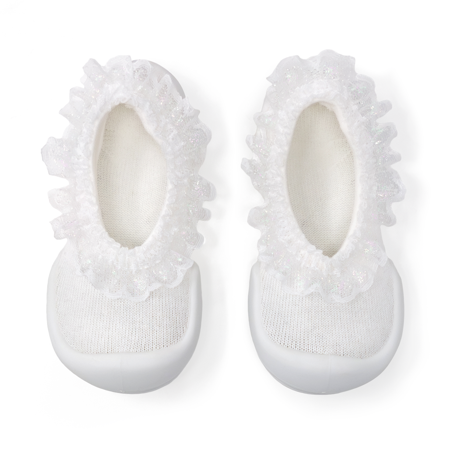 Two white baby shoes with ruffled trim.