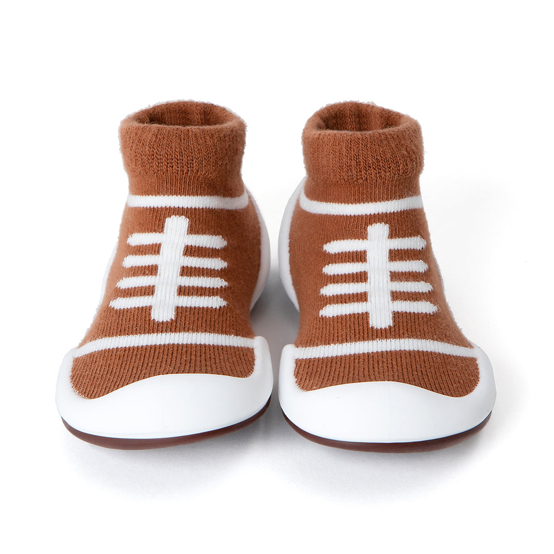 Brown and white football-themed baby shoes.