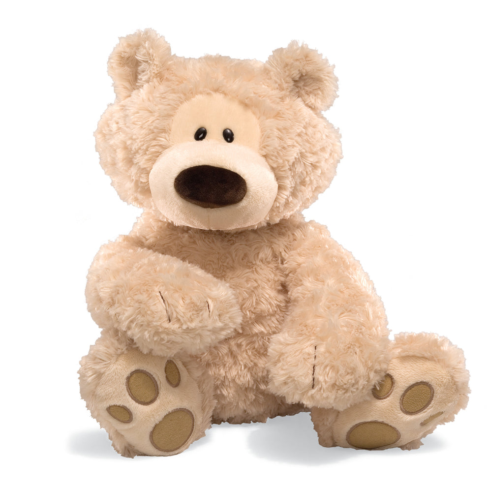 Tan fluffy teddy bear with brown nose and paw pads, seated.