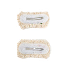 Two knitted hair clips with white fabric and silver clasps.