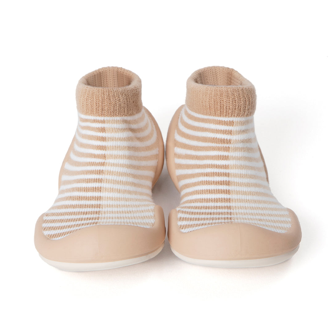 Pair of baby sock shoes with tan and white stripes.