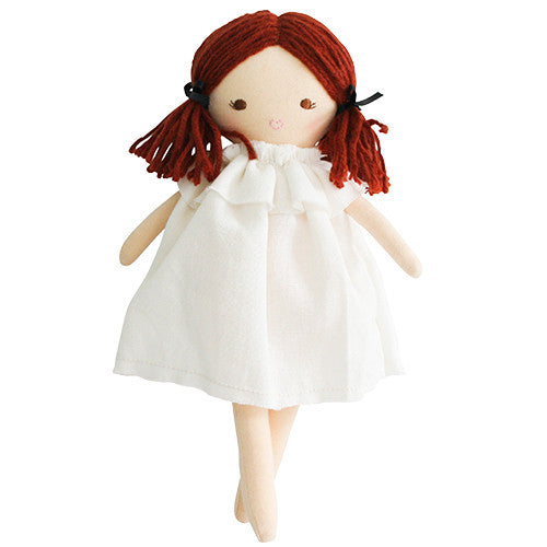 Rag doll with red yarn hair, white linen dress, pigtails tied with black ribbons.