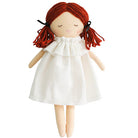 A doll with red yarn hair and a white dress.