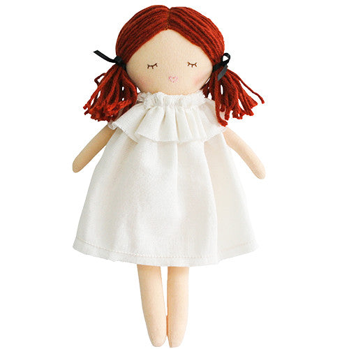 A doll with red yarn hair and a white dress.