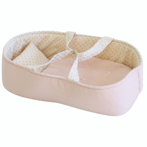 Pink fabric doll bassinet with polka dot lining.