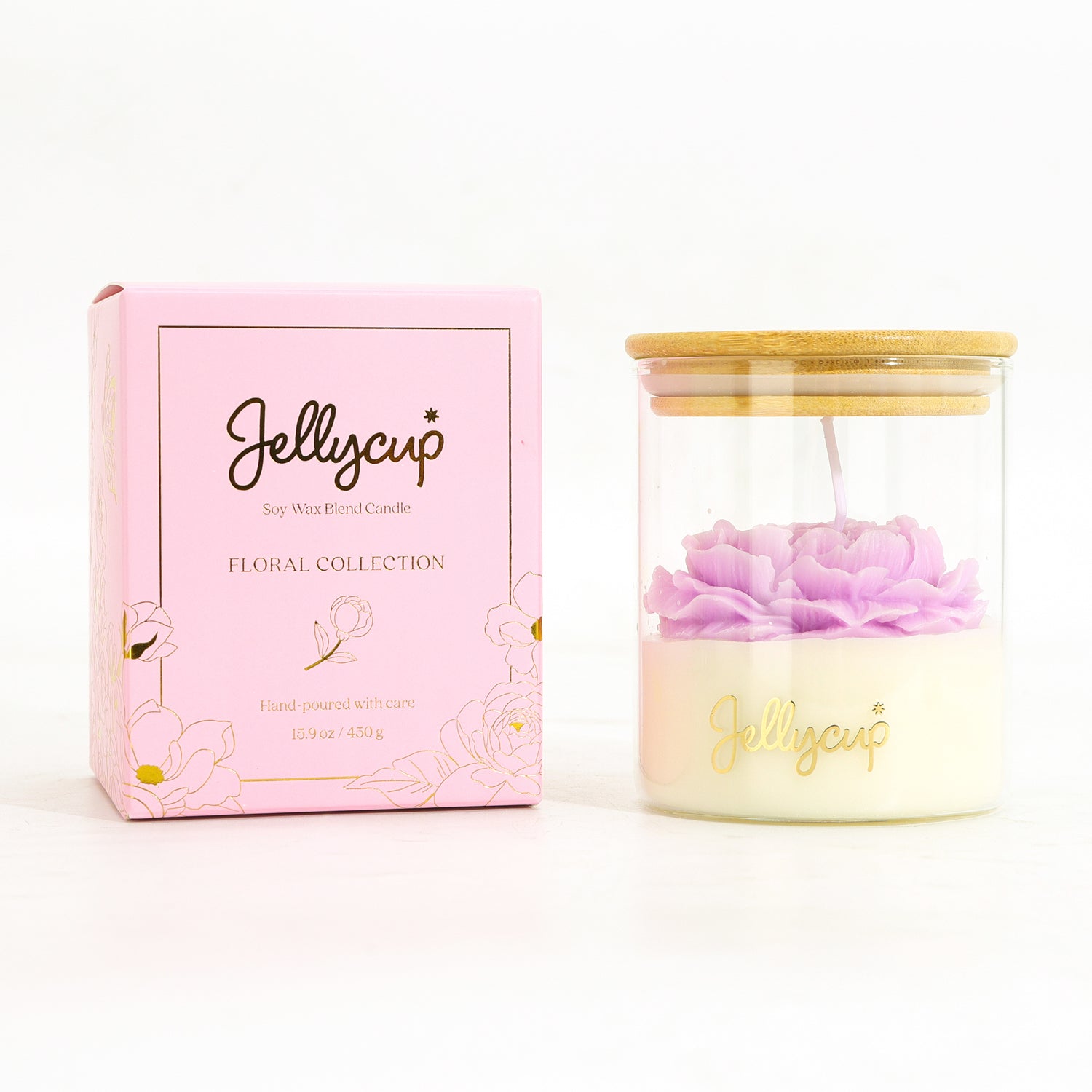 A Jellycup soy wax candle in a clear glass jar with a bamboo lid, shown next to its pink floral collection box on a white background.