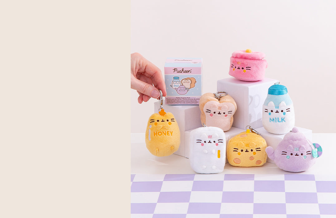 Cute plush keychains shaped like milk, honey, toast, and treats displayed on a pastel background.