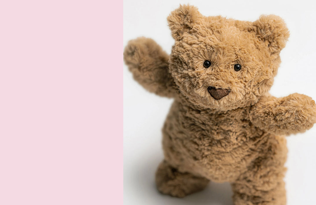 Jellycat plush bartholomew teddy bear in soft brown fur with button eyes and a stitched nose, standing upright with open arms.