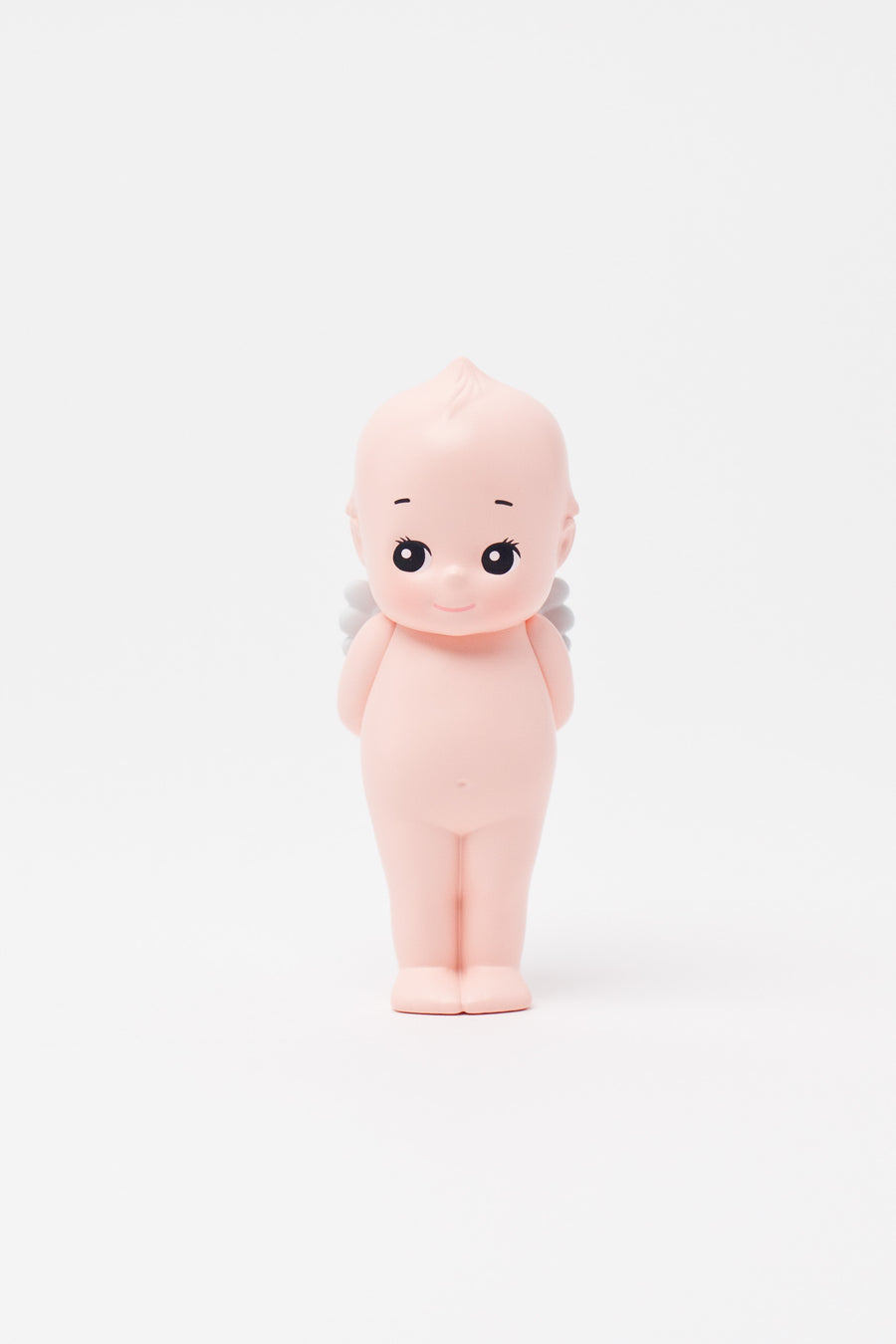 Small figurine of a baby with a bald head on a white background