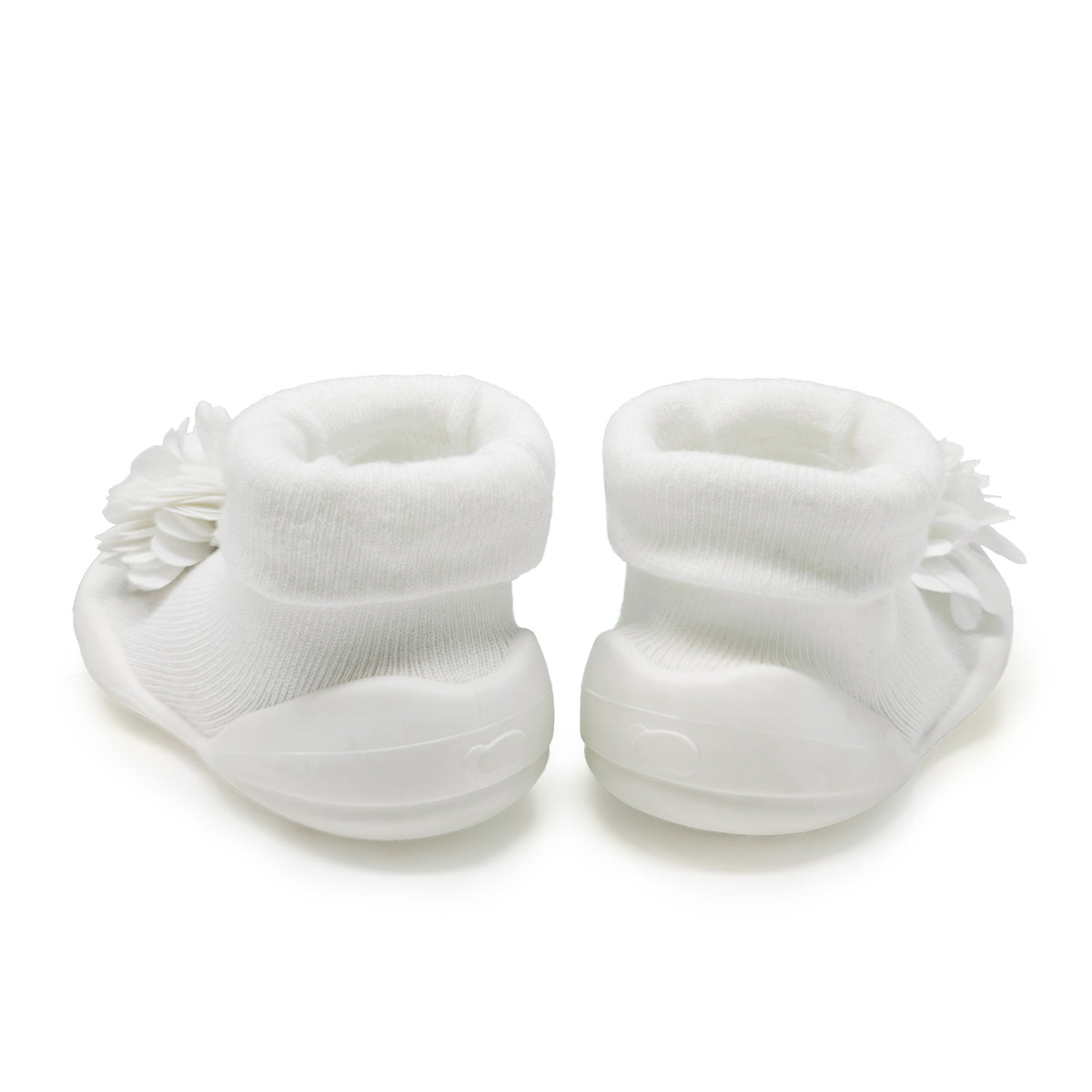 Two white baby sock-shoes with flower embellishments.