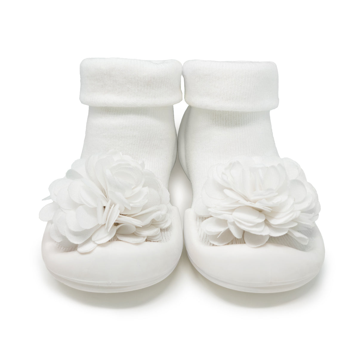 White baby shoes with flower embellishments.