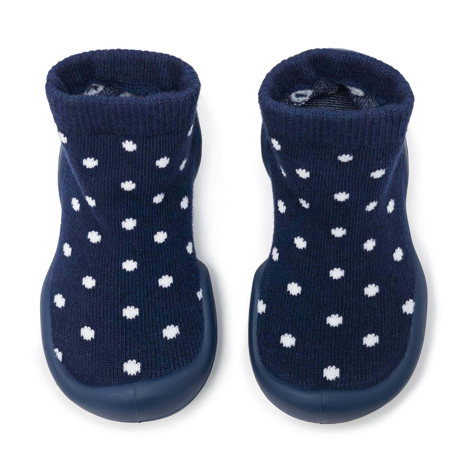 Pair of navy blue baby boots with white polka dots on a white background