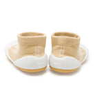 Back view of two beige baby sock shoes.