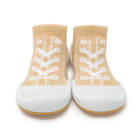 Pair of baby sock shoes in tan and white.