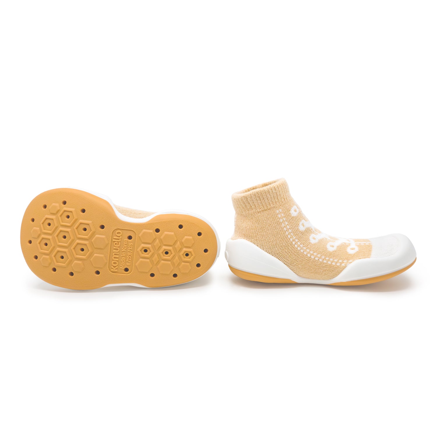 Pair of tan sock-shoes with white accents.