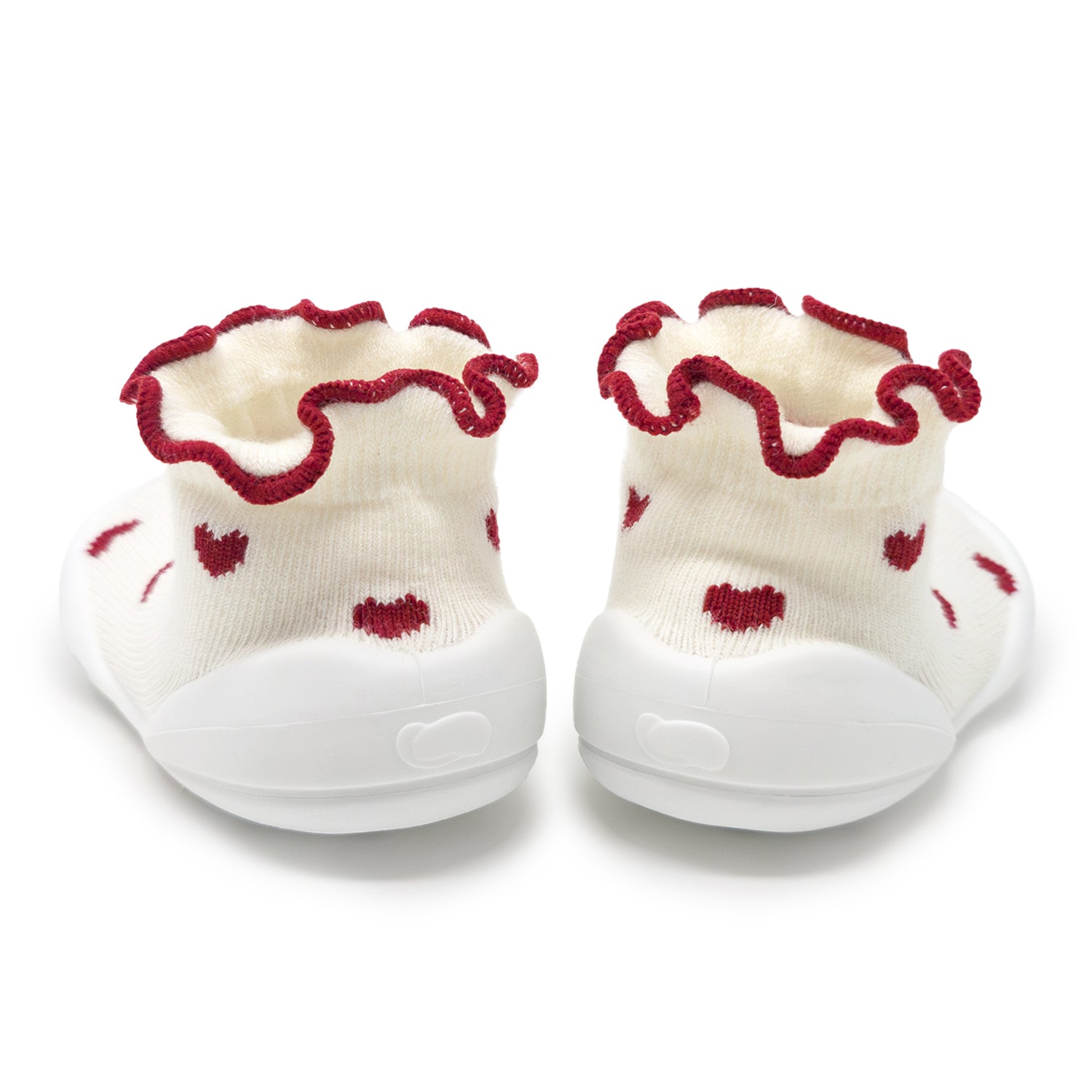 Pair of baby shoes with red hearts and ruffled edges on a white background