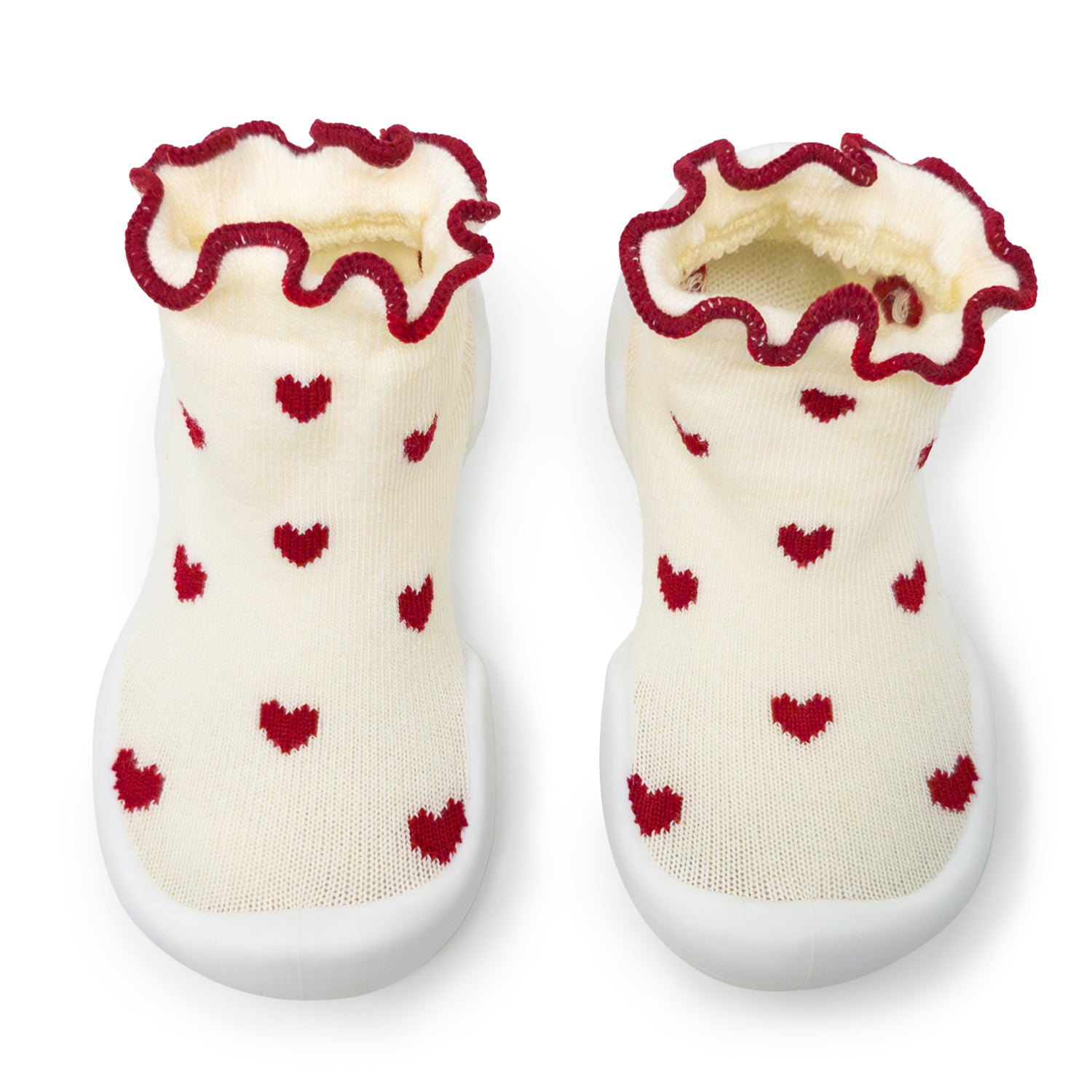 Pair of baby shoes with red heart patterns on a white background