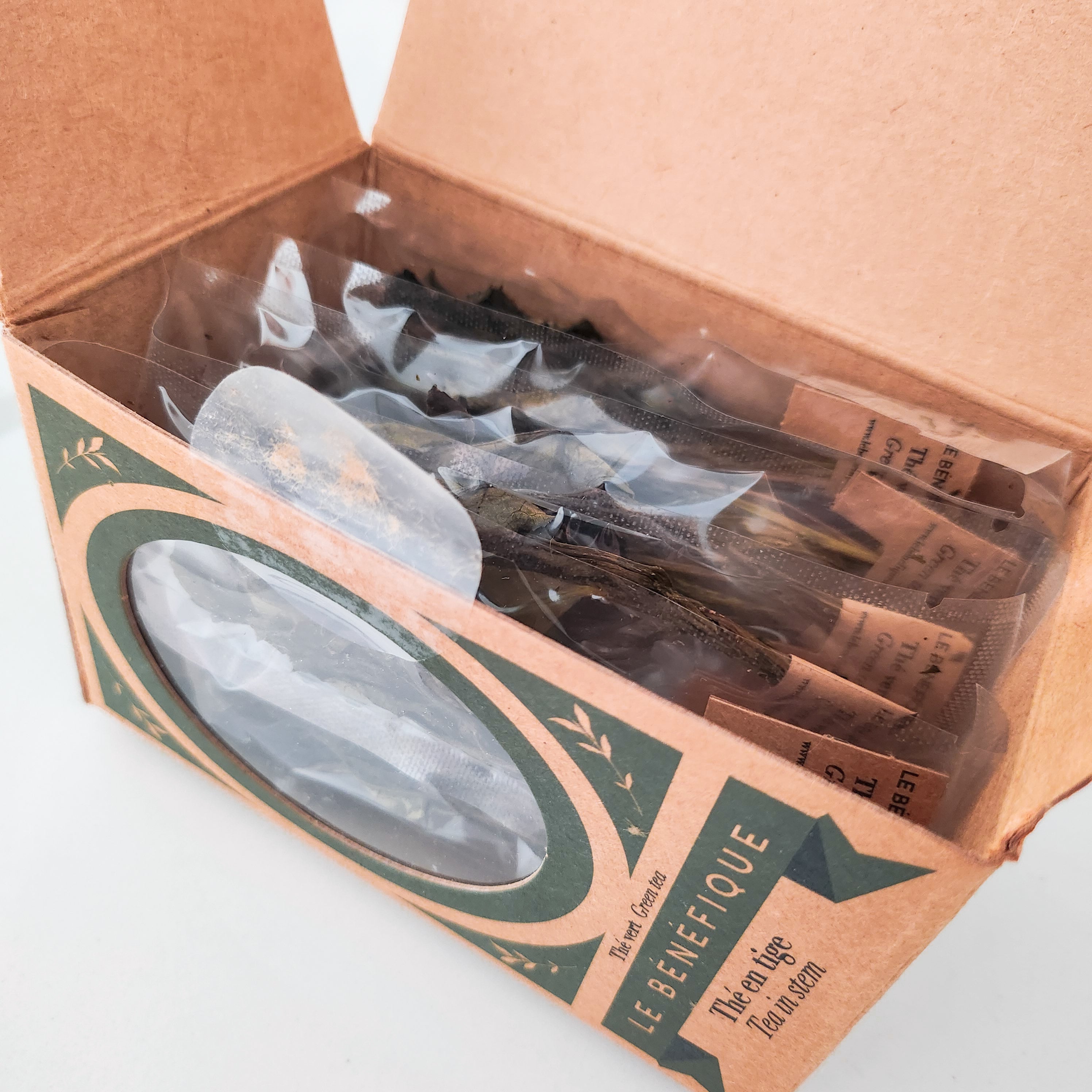 Open box of individually packaged green tea.