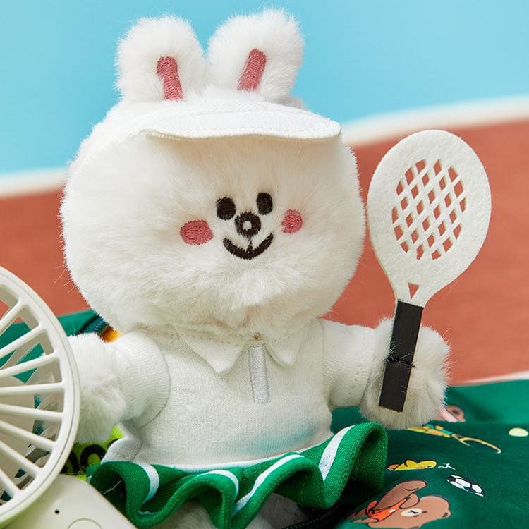 Stuffed bunny in tennis outfit with racket.