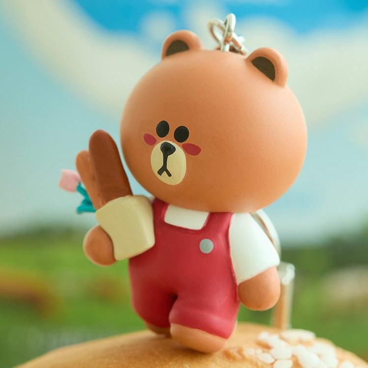 Cartoon bear figure in red overalls, holding flowers.
