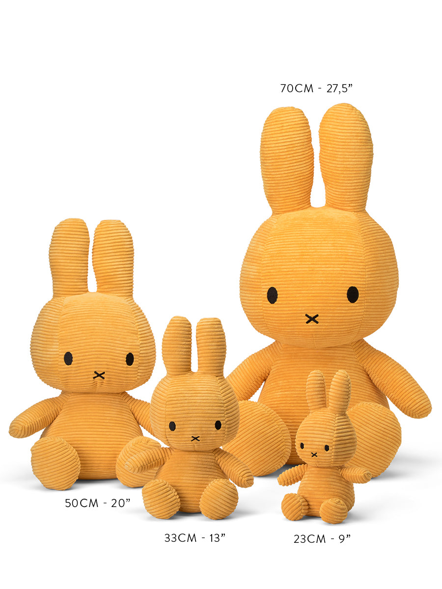 Four yellow corduroy Miffy plush toys of varying sizes, labeled with height in centimeters and inches.