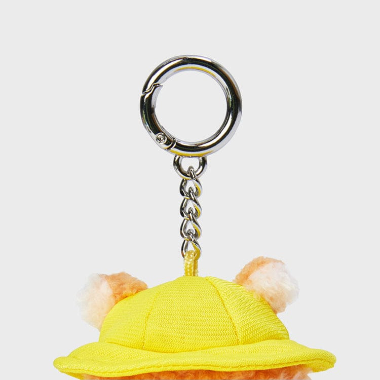 Yellow hat keychain with pom-poms.