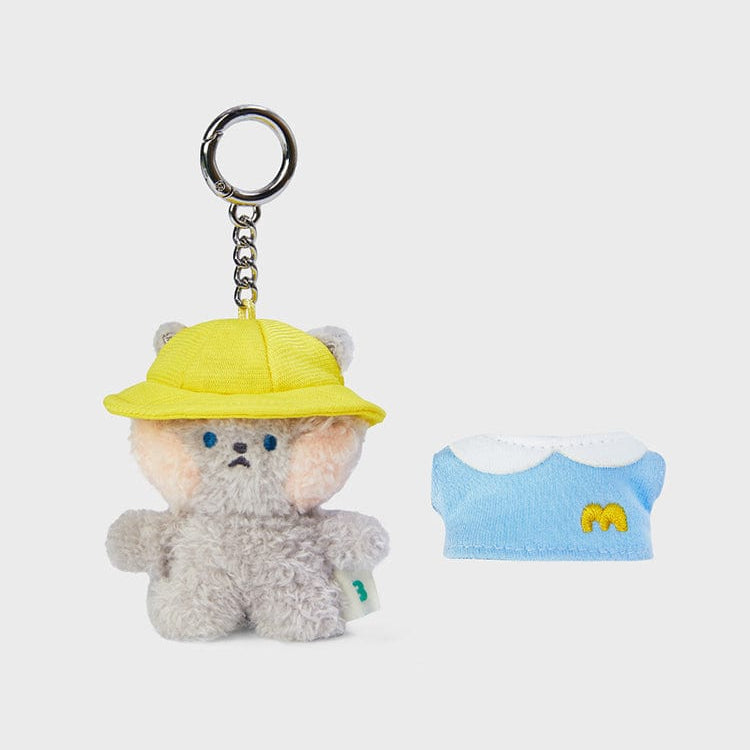 Plush bear keychain with yellow hat and blue dress.