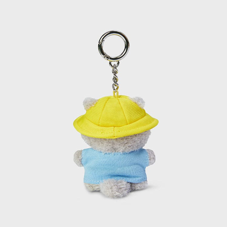 Back view of a plush keychain with a yellow hat and blue shirt.