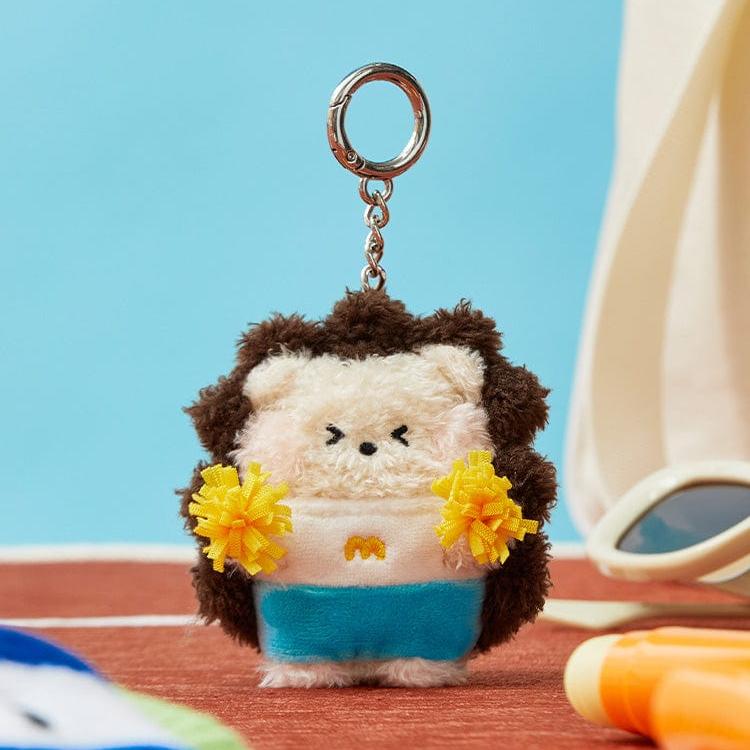 Plush hedgehog keychain with yellow pom-poms, blue outfit.