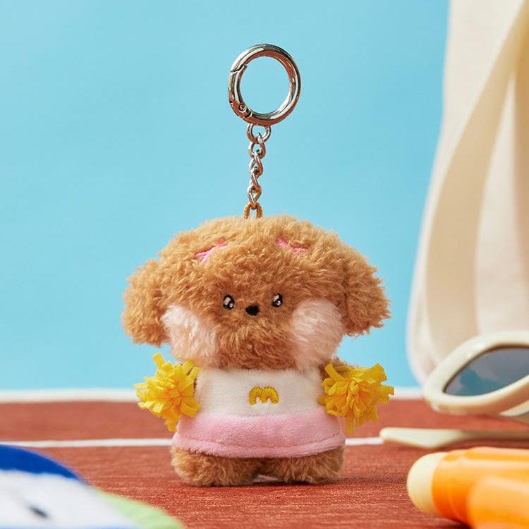 Stuffed dog cheerleader keychain with pink outfit and yellow pom-poms.