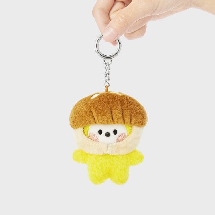 Plush yellow character keychain held by a hand.