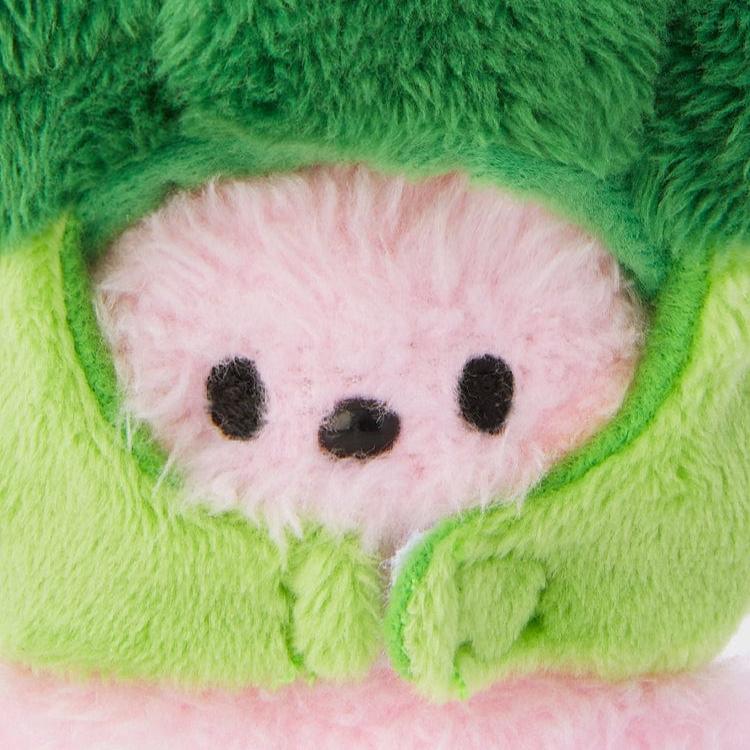 Close-up of a fluffy pink and green plush toy.