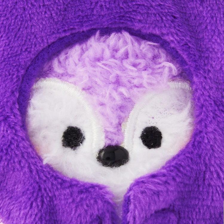 Close-up of a purple, furry animal plush toy with a hood.