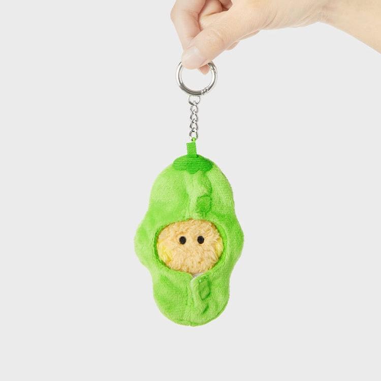 Hand holding an avocado plush keychain.