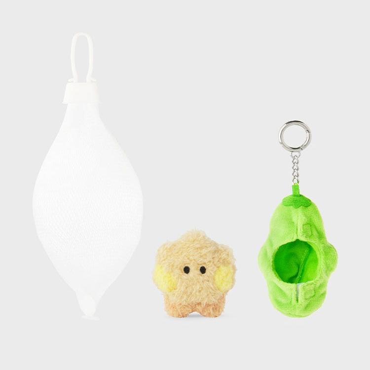 Three plush toys: a white teardrop-shaped bag, a tan star with yellow ears, and a green avocado keychain.